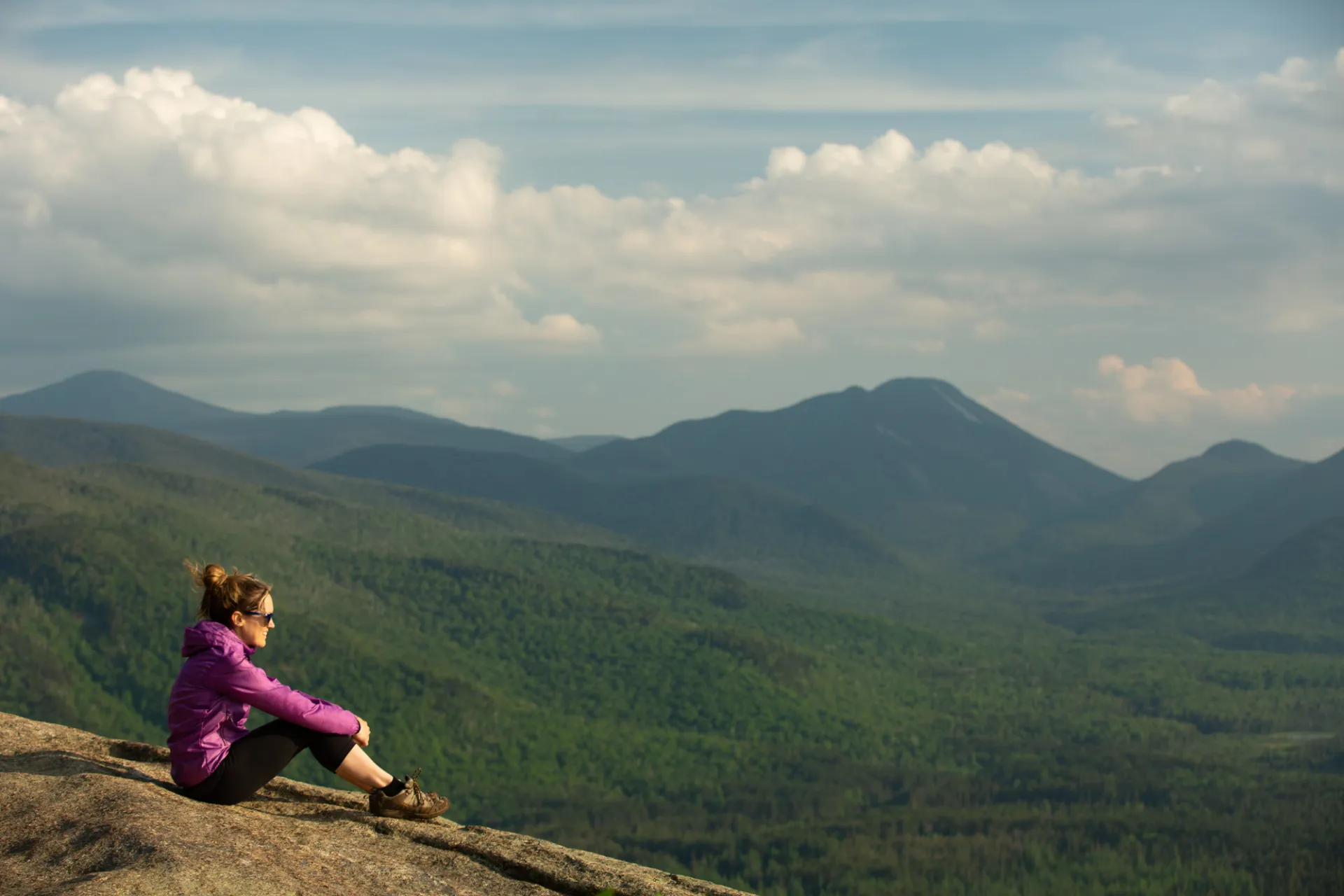A hiker on a summit during the spring