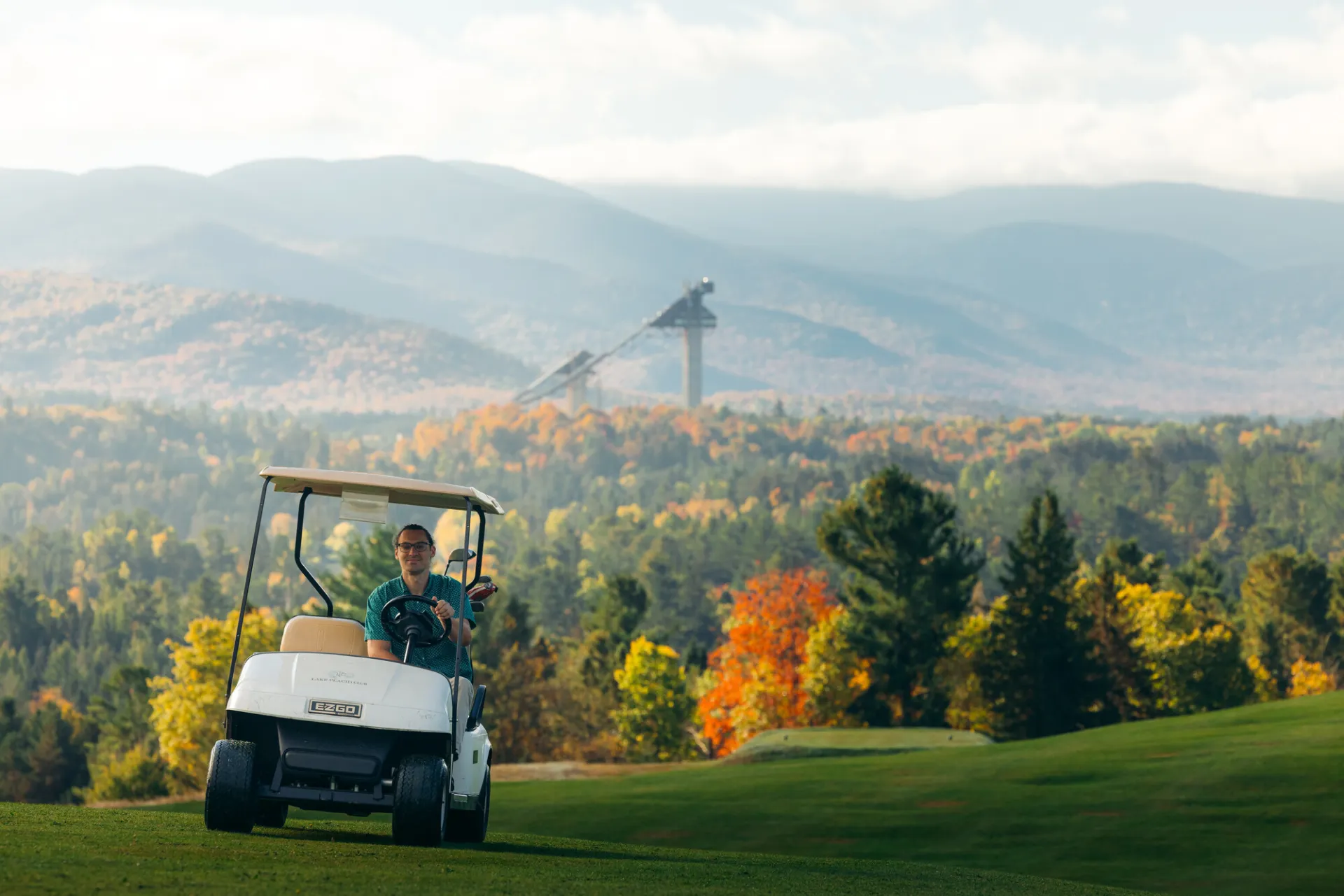 Driving a golf cart through fall scenery.