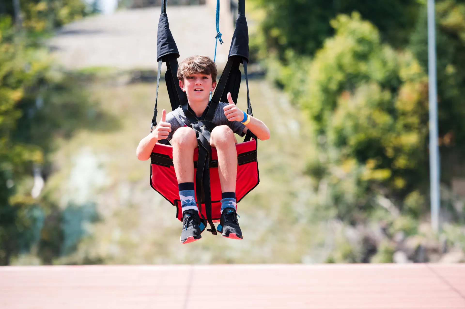 Child give thumbs up fro the zip Line
