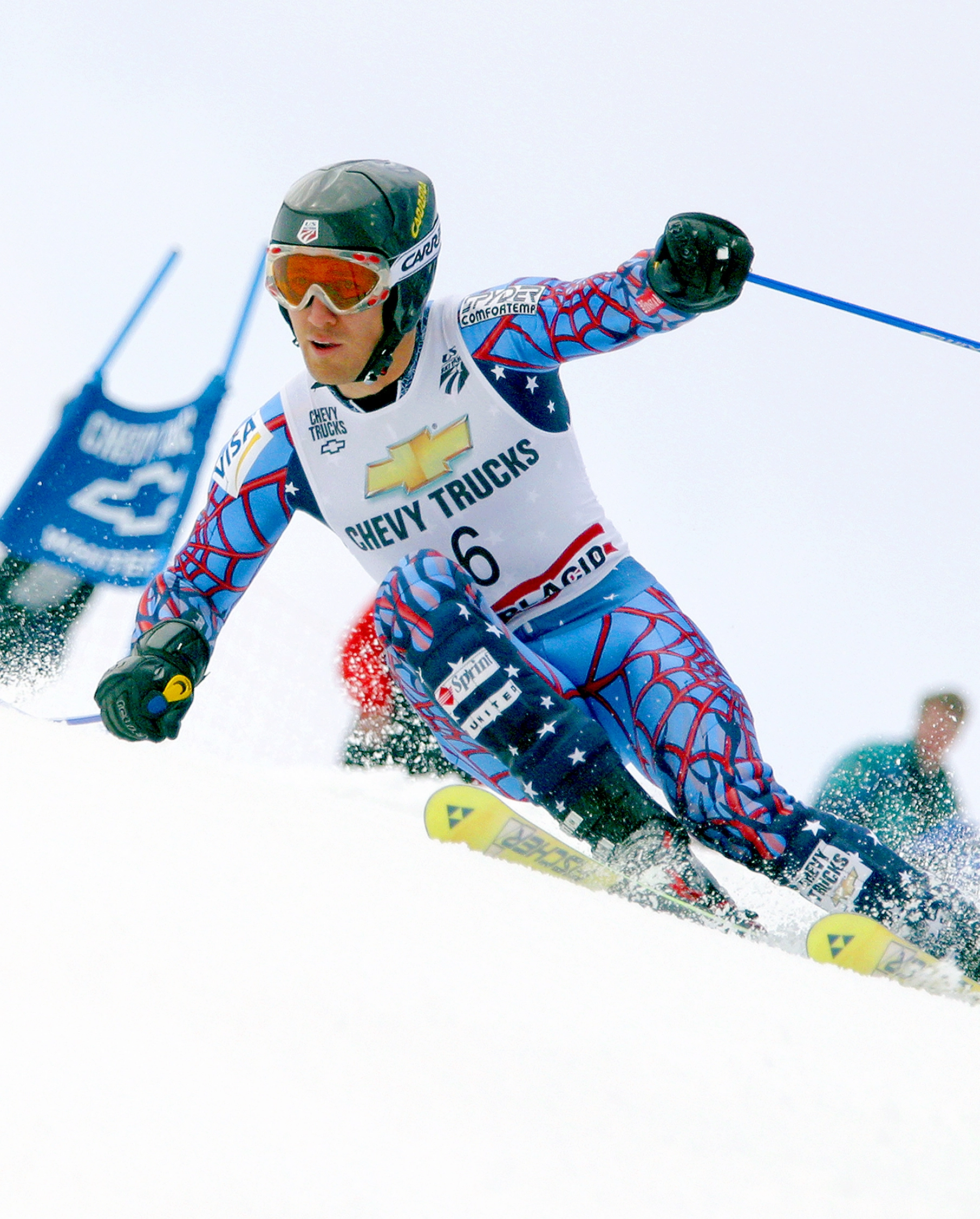 An alpine skier races down a course at a world-class competition.