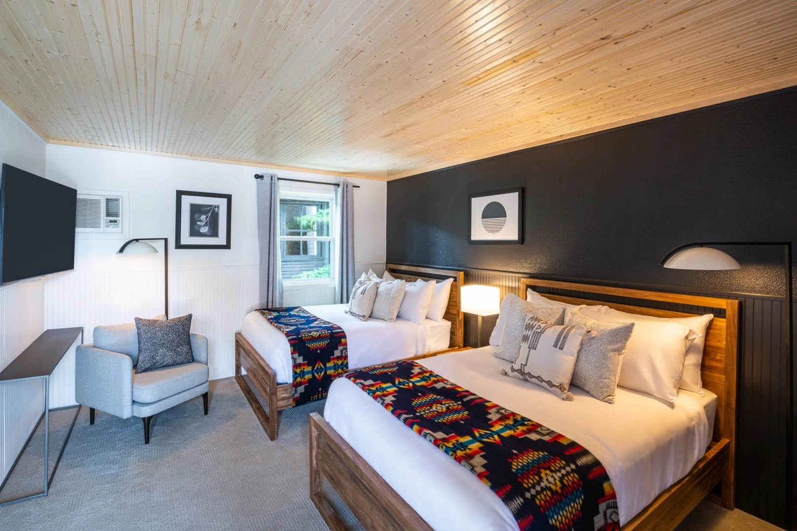 White linens on the bed with ample throw pillows