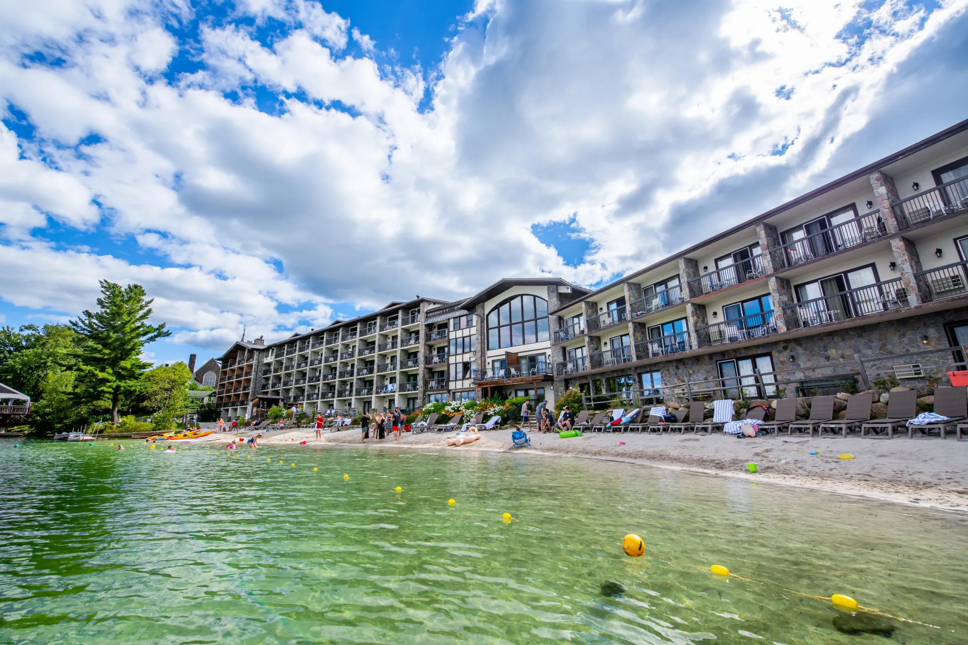 Looking up at the lakeside of Golden Arrow Lakeside Resort from in Mirror Lake on the sandy beach.