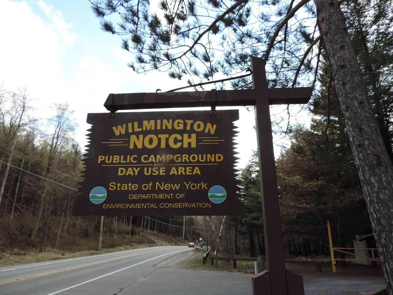 A brown and yellow wooden sign for Wilmington Notch.