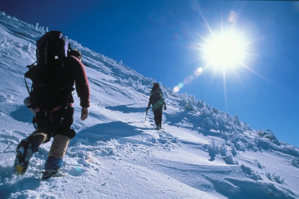 Hiking a path on snow covered slopes.