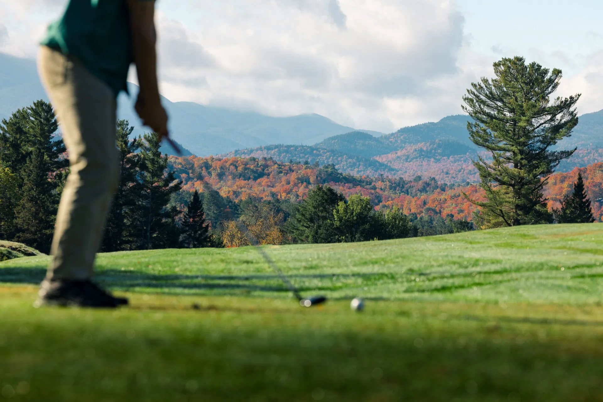 A person golfing in the fall.