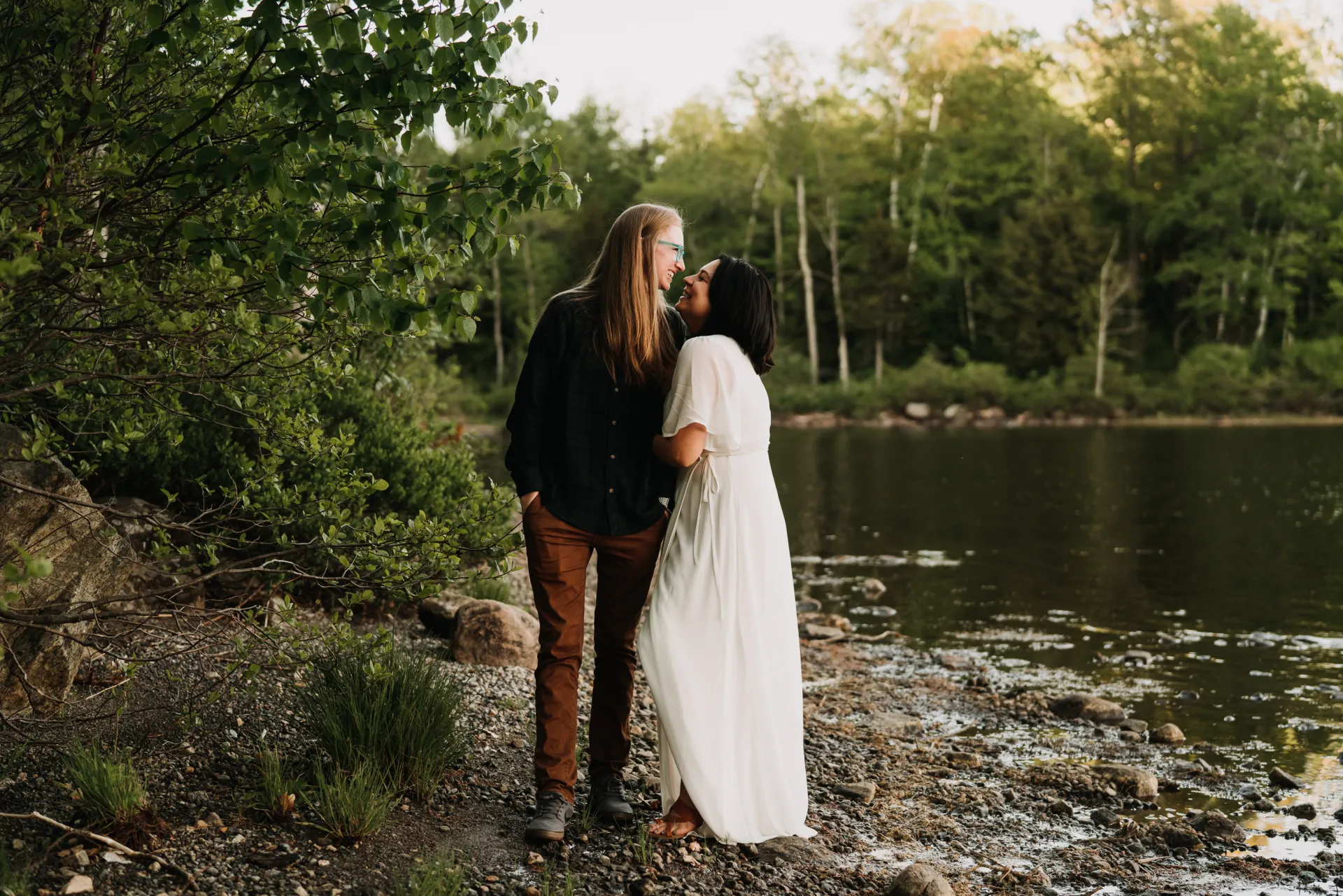 a wedding couple by a stream
