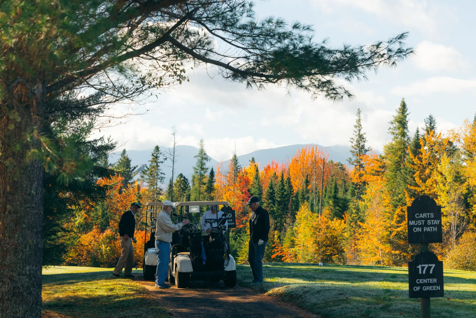 Driving a golf cart on a fall fairway.