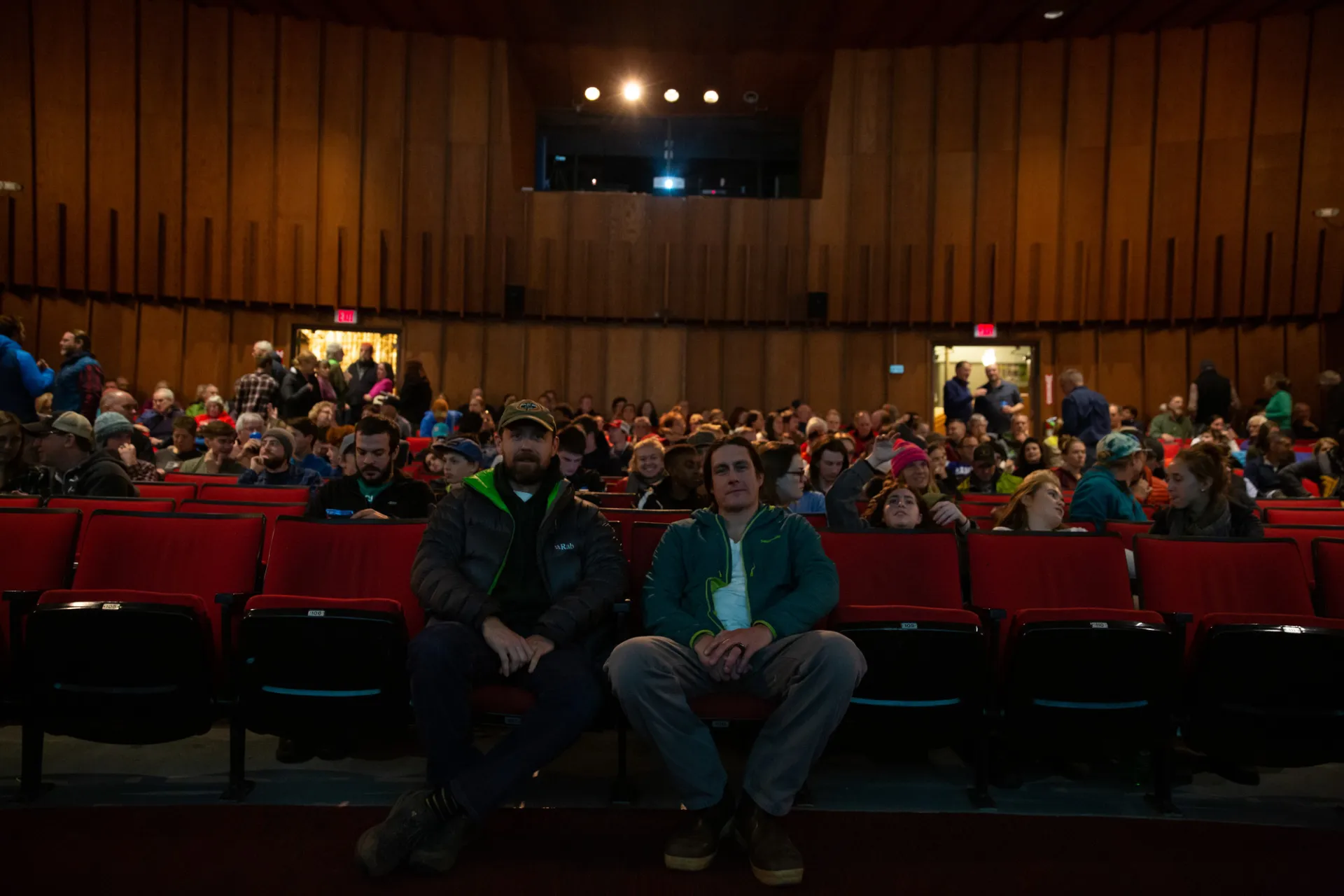 A group of people sitting in the Palace Theatre.