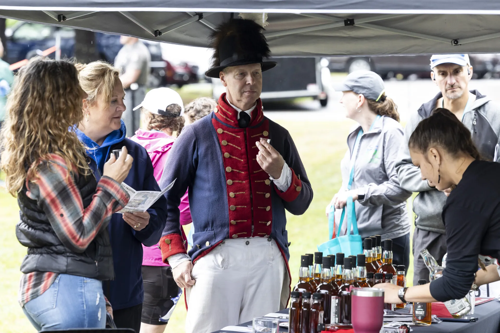 Re-enactor and guests sample whiskey
