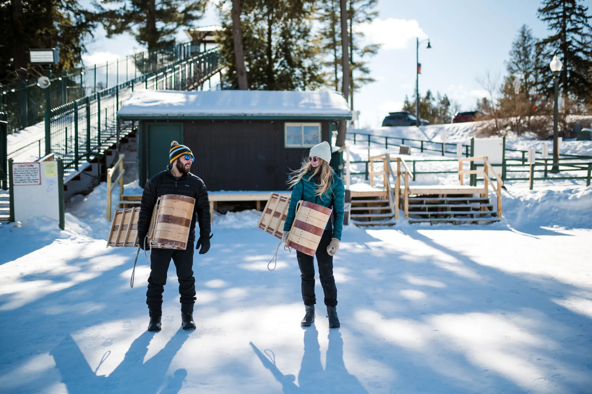 A couple going bobsledding in winter.