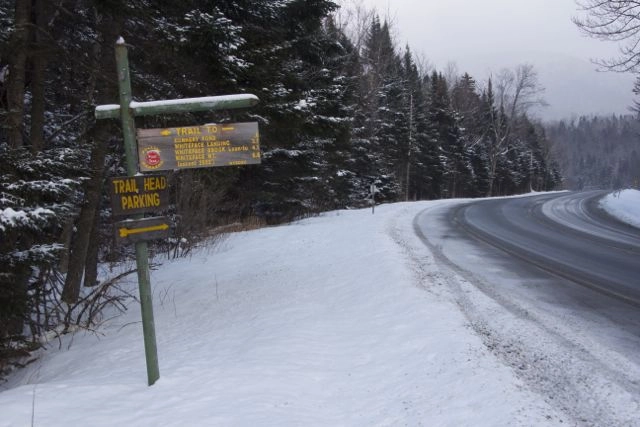 Trailhead sign indicating milages and where to park