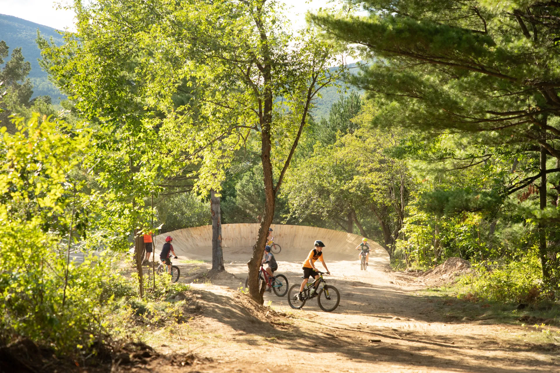 Big burm wall in the woods with young kids practicing