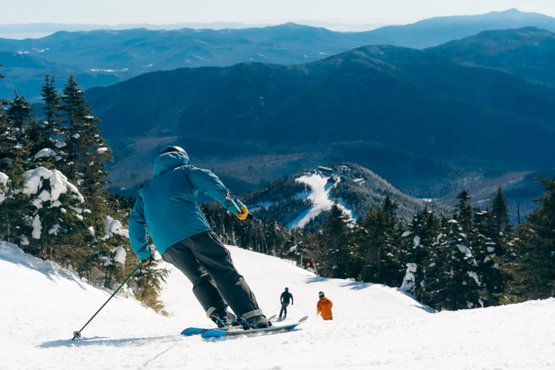 A man skis down a snowy mountain. 