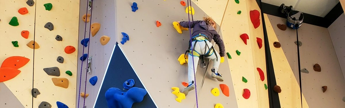 Climber nears the top of the climbing wall