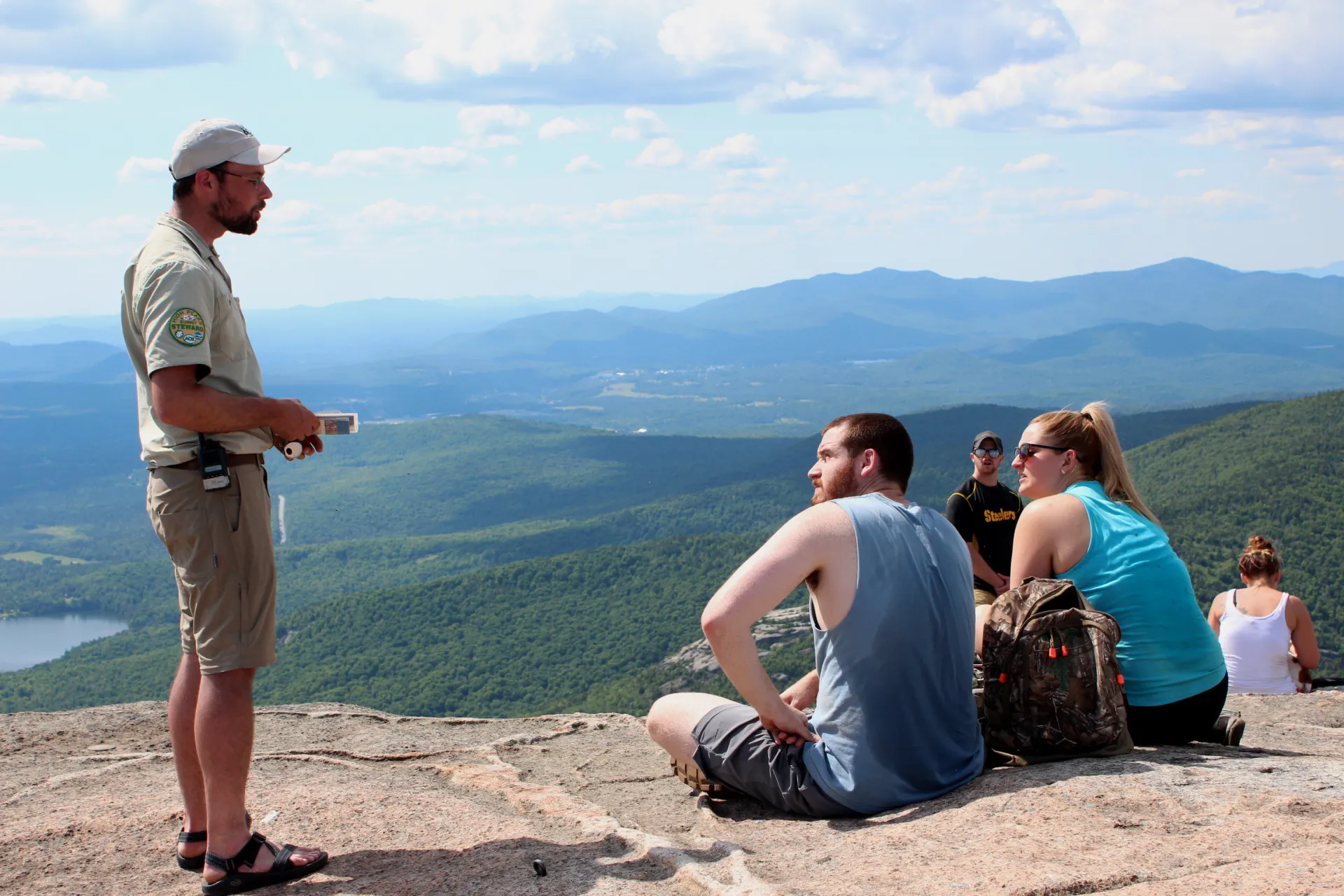 A summit steward educates hikers on the fragile alpine vegetation on Cascade's summit.