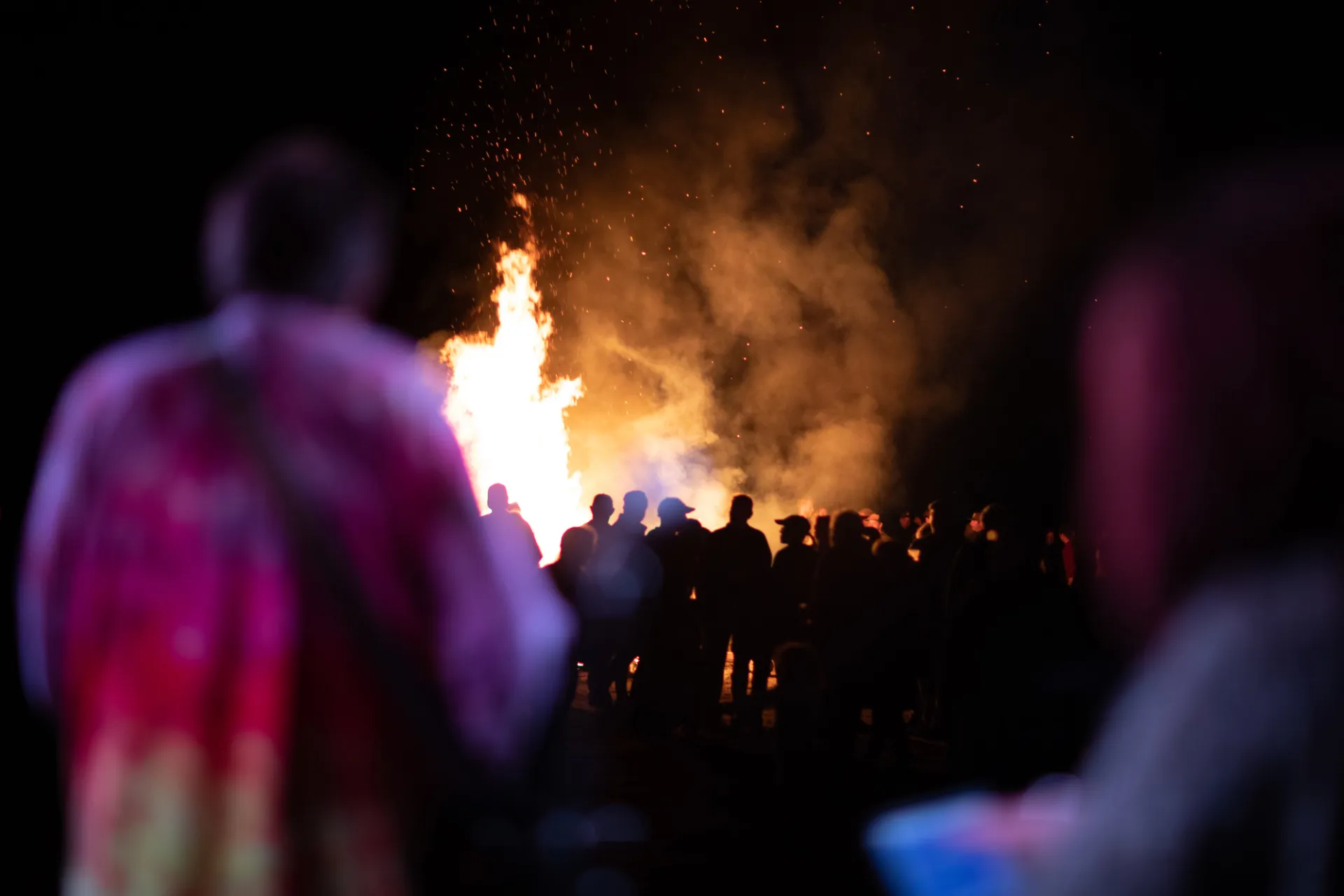 Backed up view of the crowd in front of the bonfire