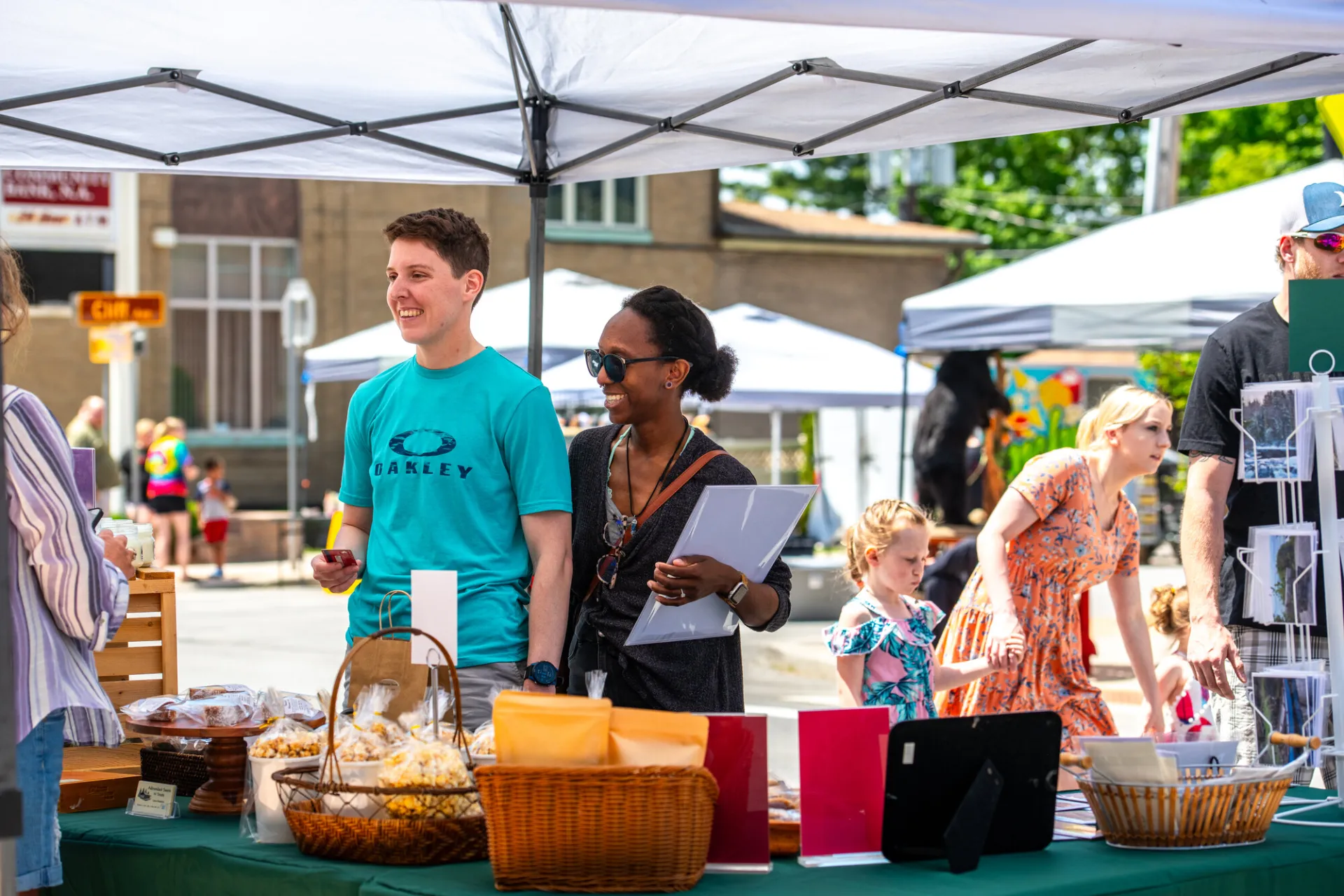 A crowd of people enjoying an event during a sunny day.