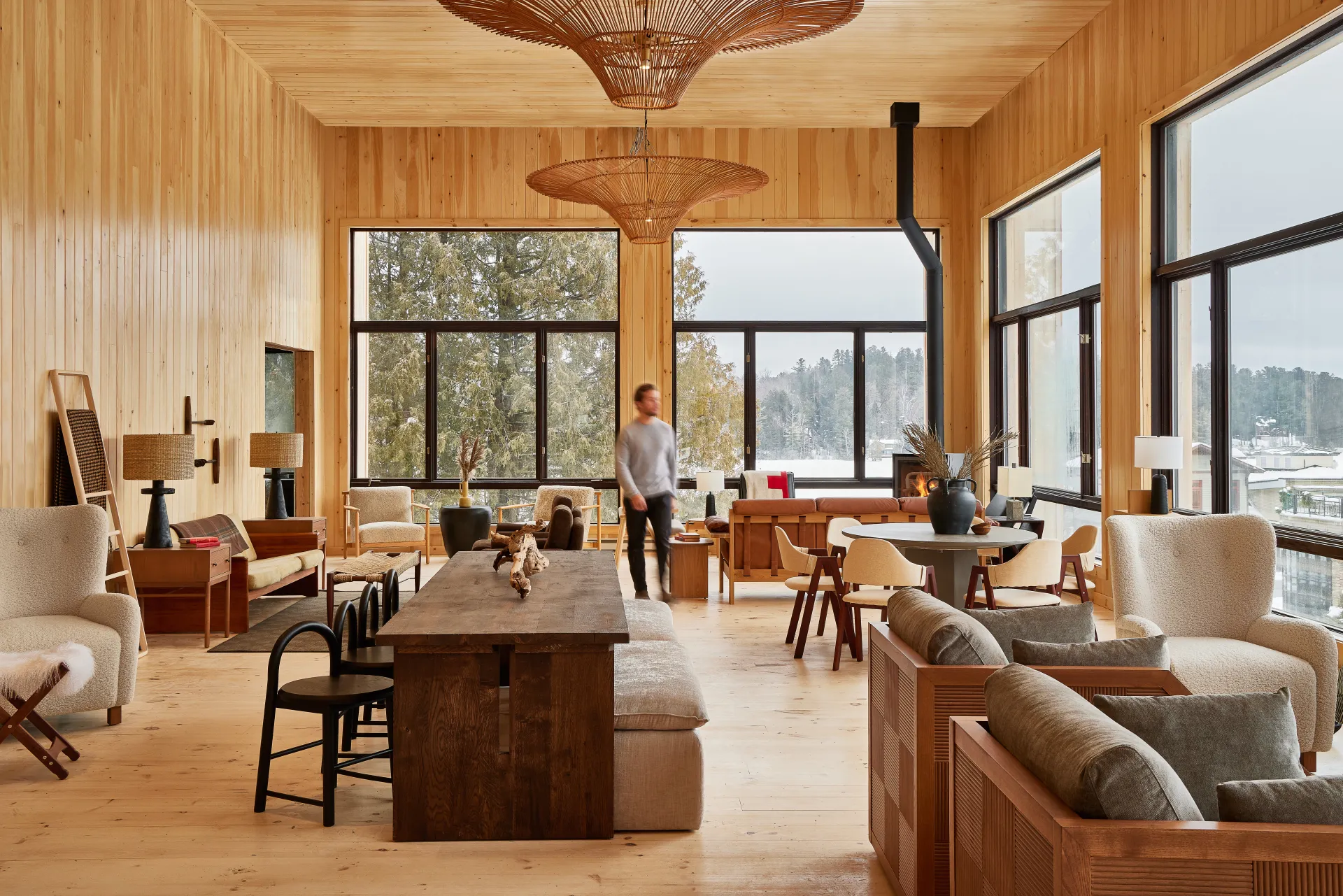 The main lounge with lots of clusters of chairs, huge windows and a fireplace.