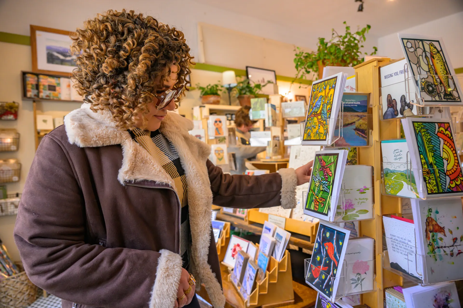 Woman looks at a card in a store in Lake Placid