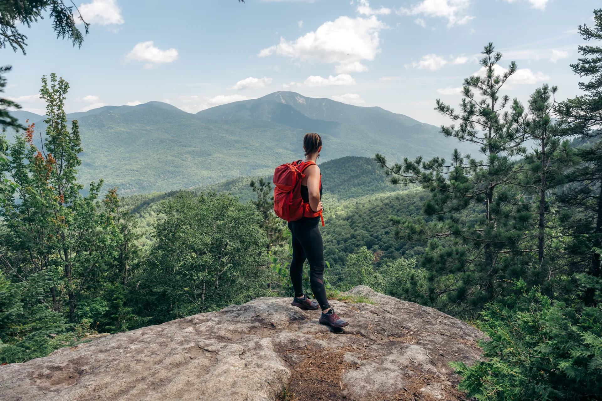 Hiker takes in the view from overlook near Rooster Comb summit