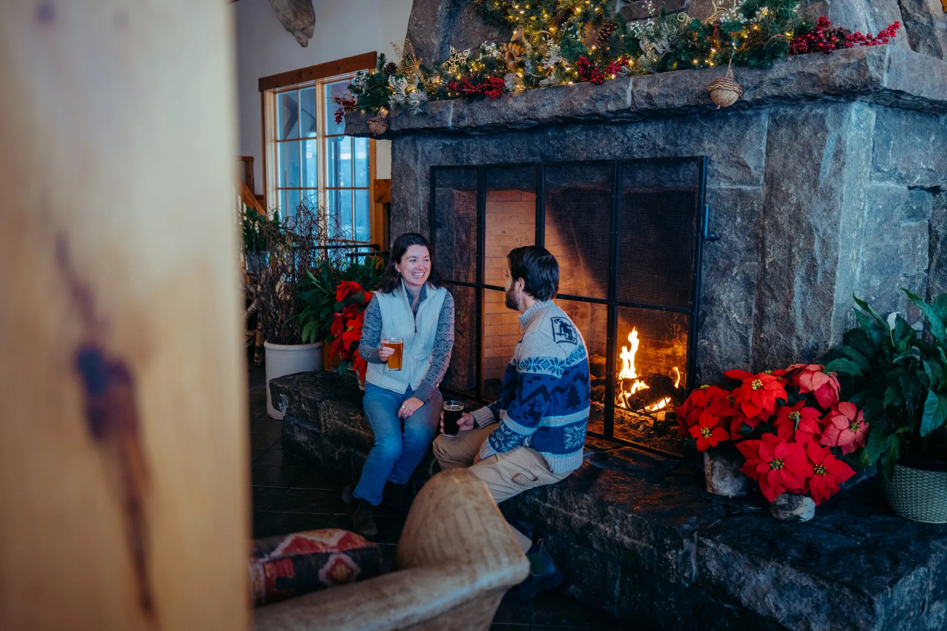 A couple sitting by a fire.