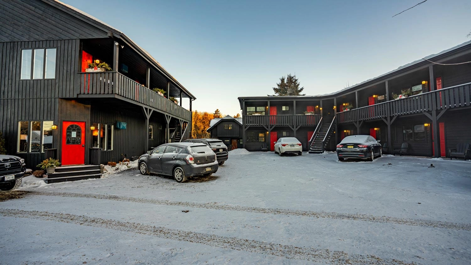 A snow covered parking lot at Placid Bay Hotel.