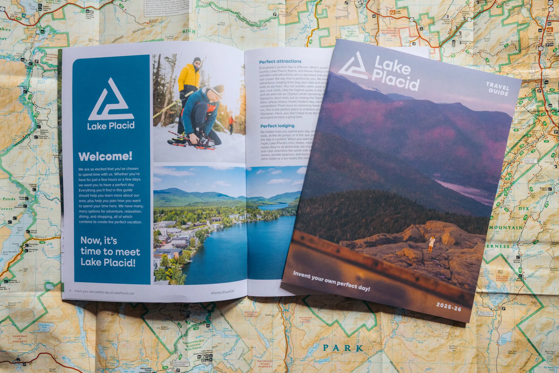 A visitor guide lies open on a map of the Adirondacks.