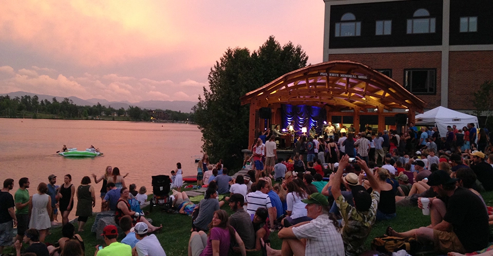 Sunset over Mirror Lake as crowd watchings a live music performance from Mid's Park