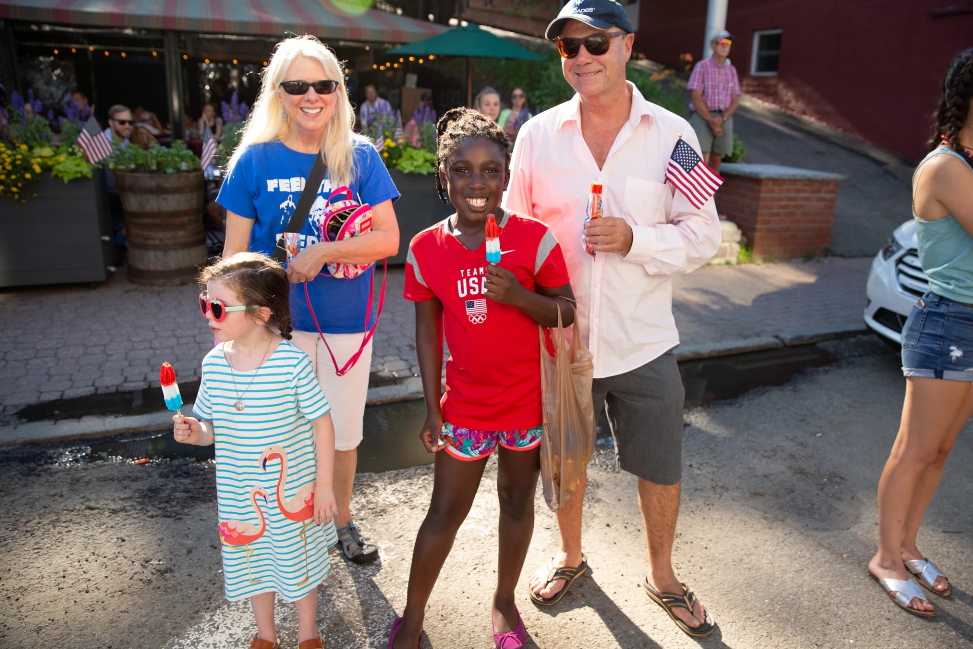 Family enjoys popsicles while waiting for the parade to start