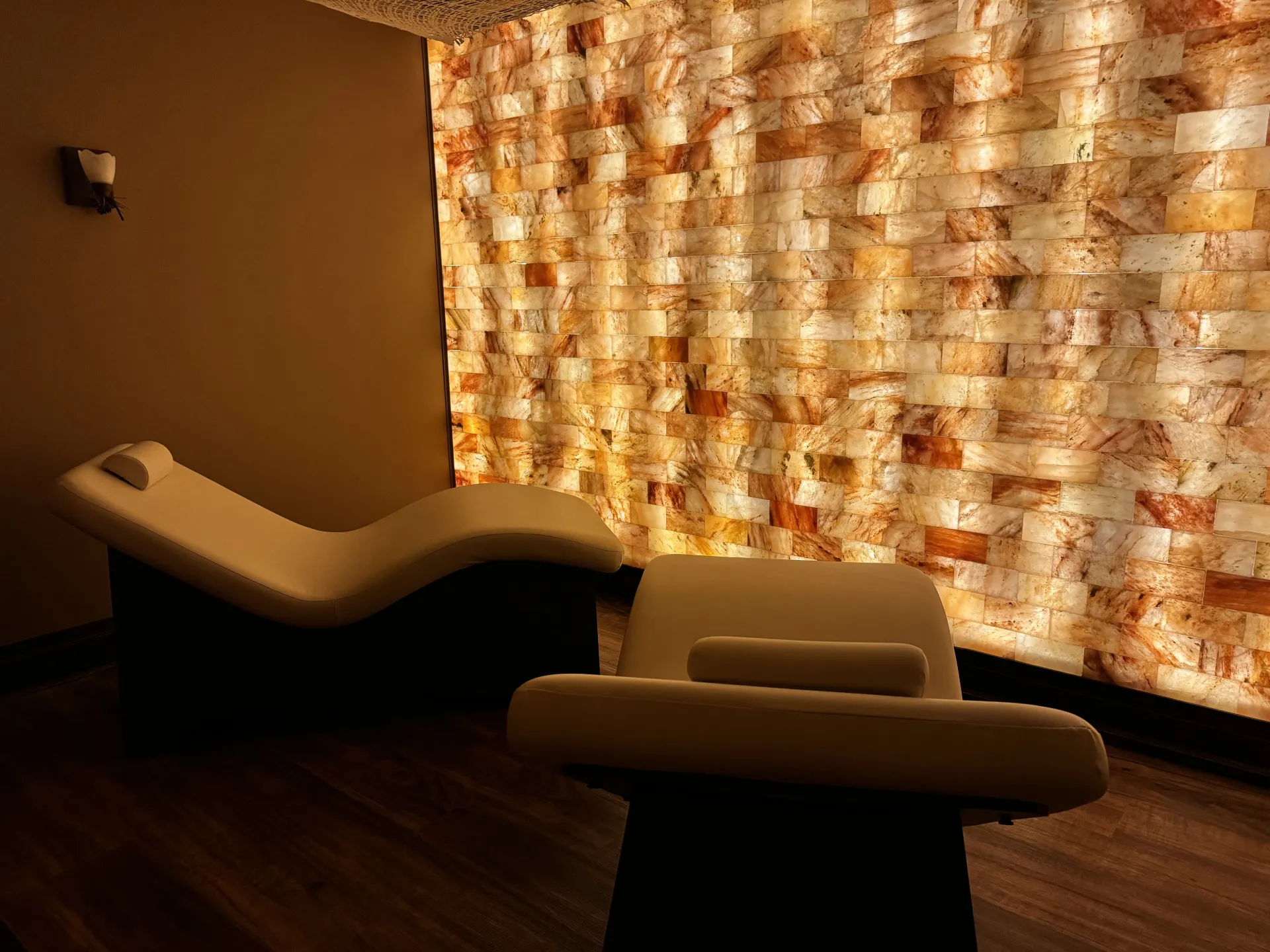 Wall of salt blocks iluminated from behind creating the warm glow to make you breathe easier