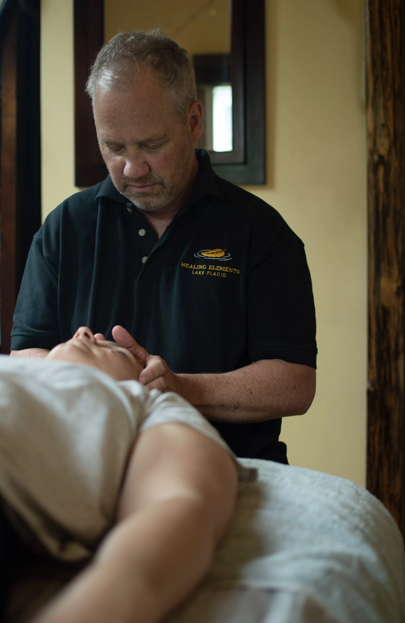 A massage therapist focuses on the facial muscles during a massage a.t Healing Elements