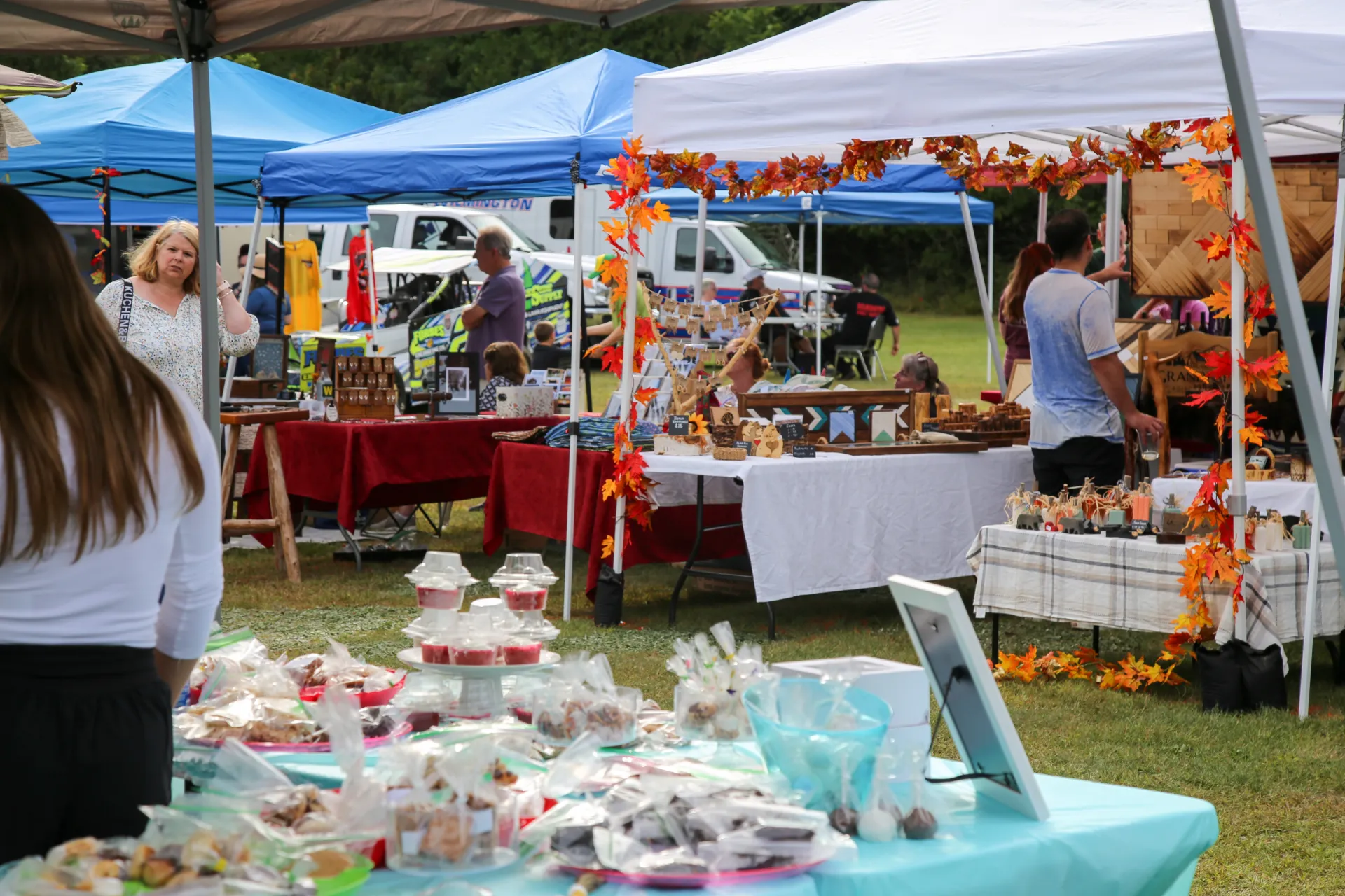 View of fall festival vendor tents seen through another vendor's tent