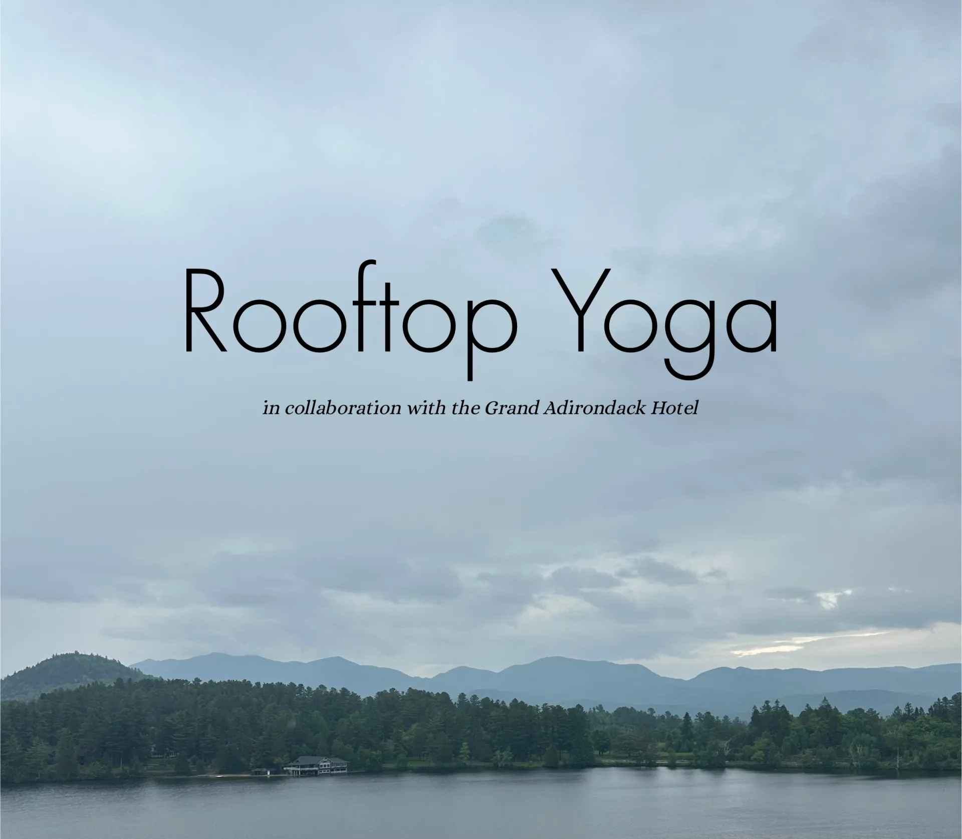 Rooftop Yoga in collaboration with the Grand Adirondack Hotel.  A calm lake and mountain range are visible in the background.