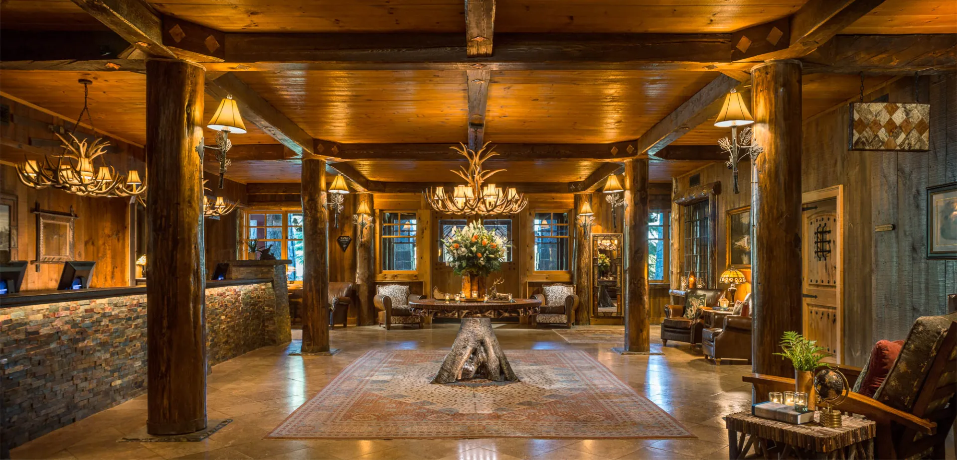 Lobby with wooden beams and marble floor.