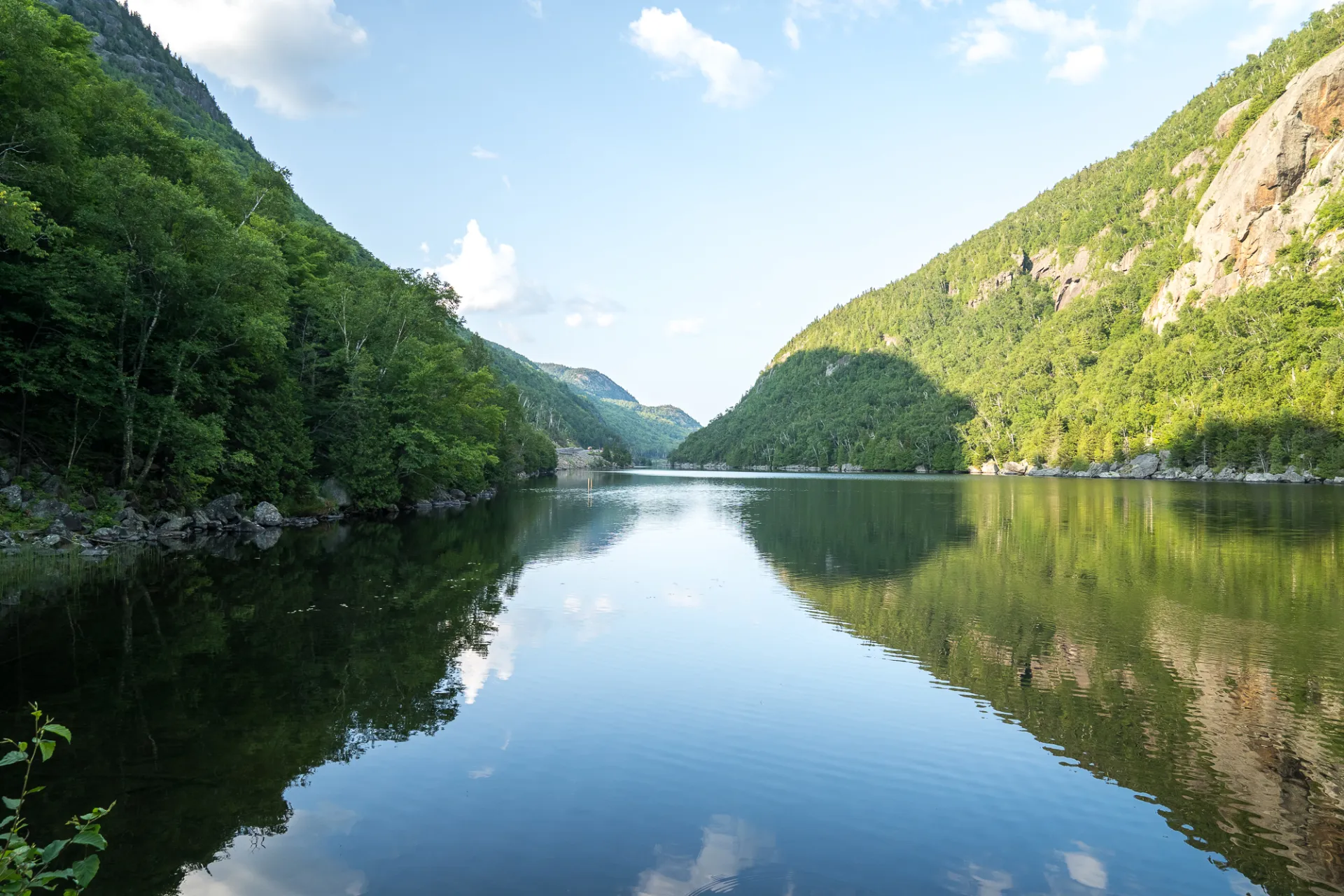 A lake mirroring the mountains surrounding it