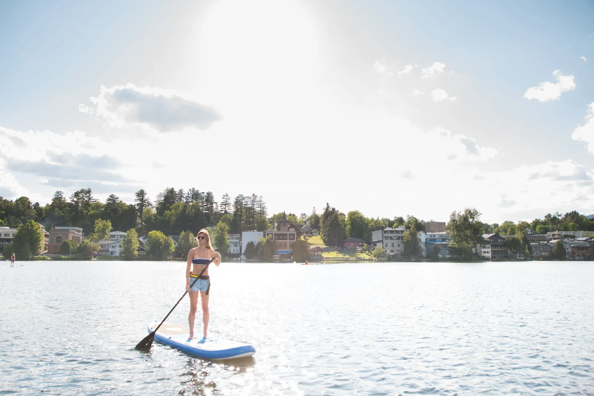 A woman paddleboarding on Mirror Lake.