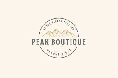 A logo badge split by a mountain and the words Peak Boutique and ringed with At the Mirror Lake Inn Resort and Spa