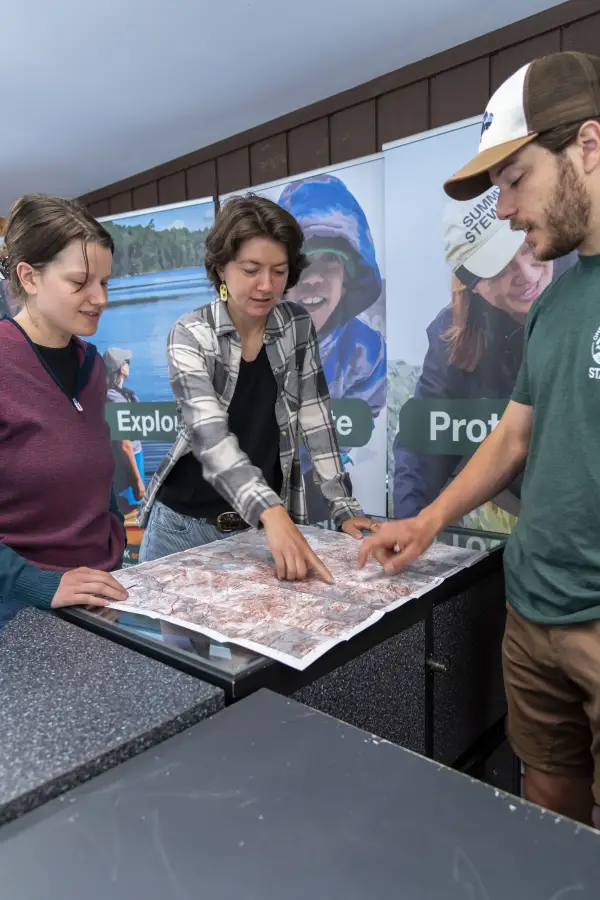 People looking at a hiking map.