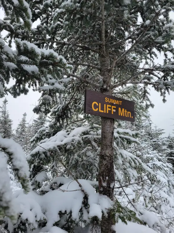 A wooden sign for the summit of Cliff Mountain
