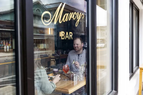A man and woman enjoy lunch at marcy bar. 