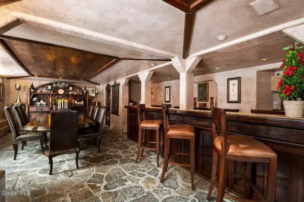 The private dining room with bar area and large table with plush leather chairs.