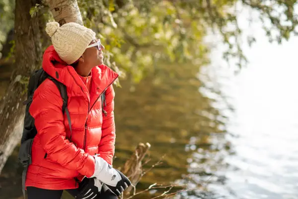 A woman look at a pond from its shores