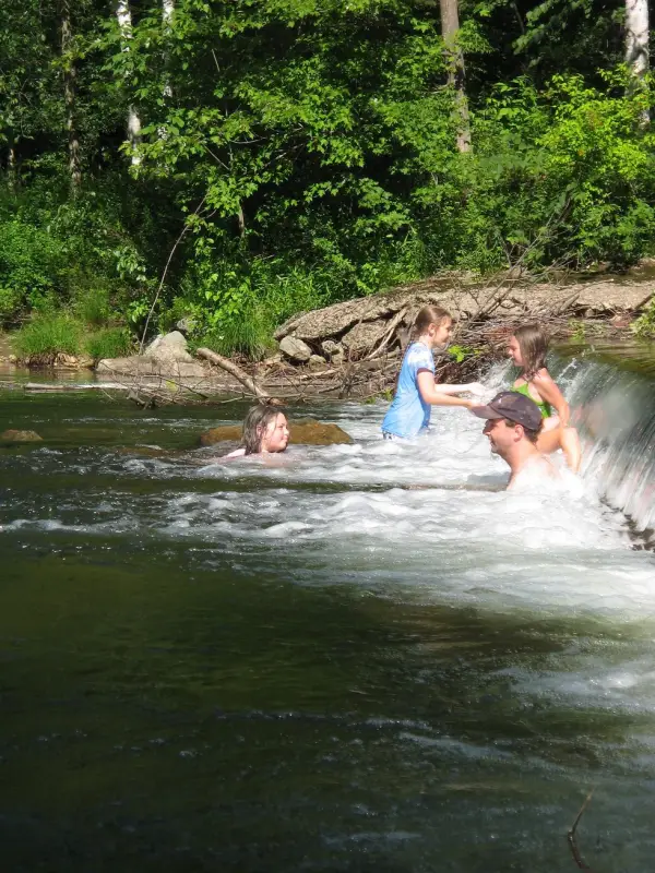 People relaxing and playing in a river
