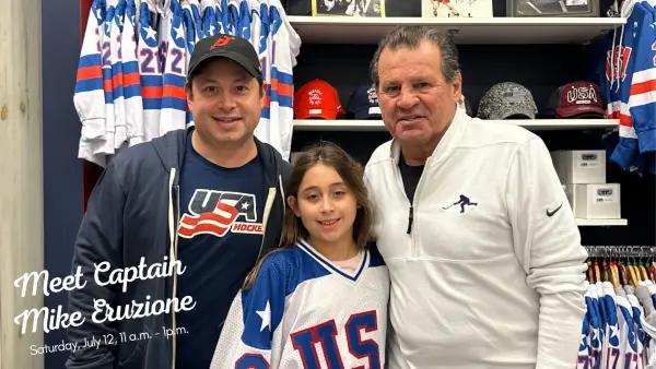 Two fans pose with Mike Eruzione. The text on the image says "Meet Captain Mike Eruzione, Saturday July 12, 11 a.m. - 1 p.m."