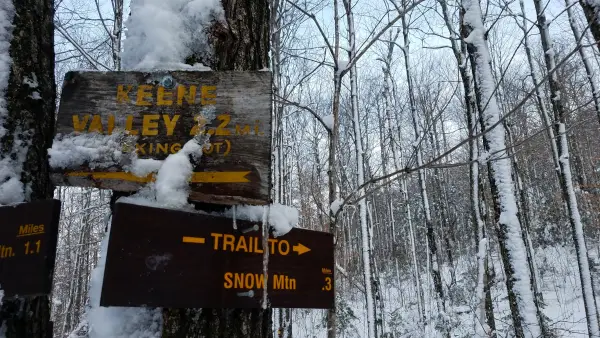 A wooden sign for Snow Mountain