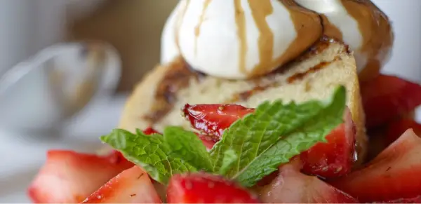 Always have dessert!  Delicious cake topped with ice cream and strawberries