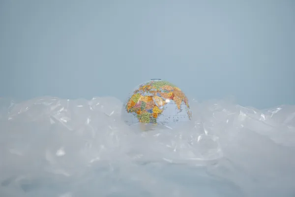 Stock image of small globe sitting atop scrunched plastic