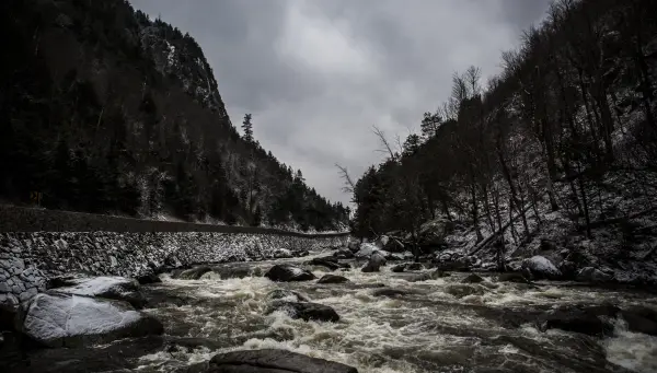 A shallow rock river through a mountain pass