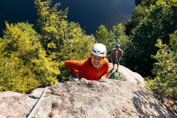 A rock climber ascends a blunt arete