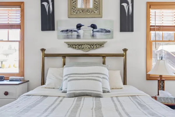 A lush bed with loon images on the lower level at Lake Placid Pinehill Townhouse.